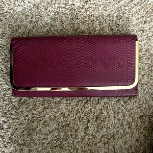Faux snakeskin burgundy clutch!